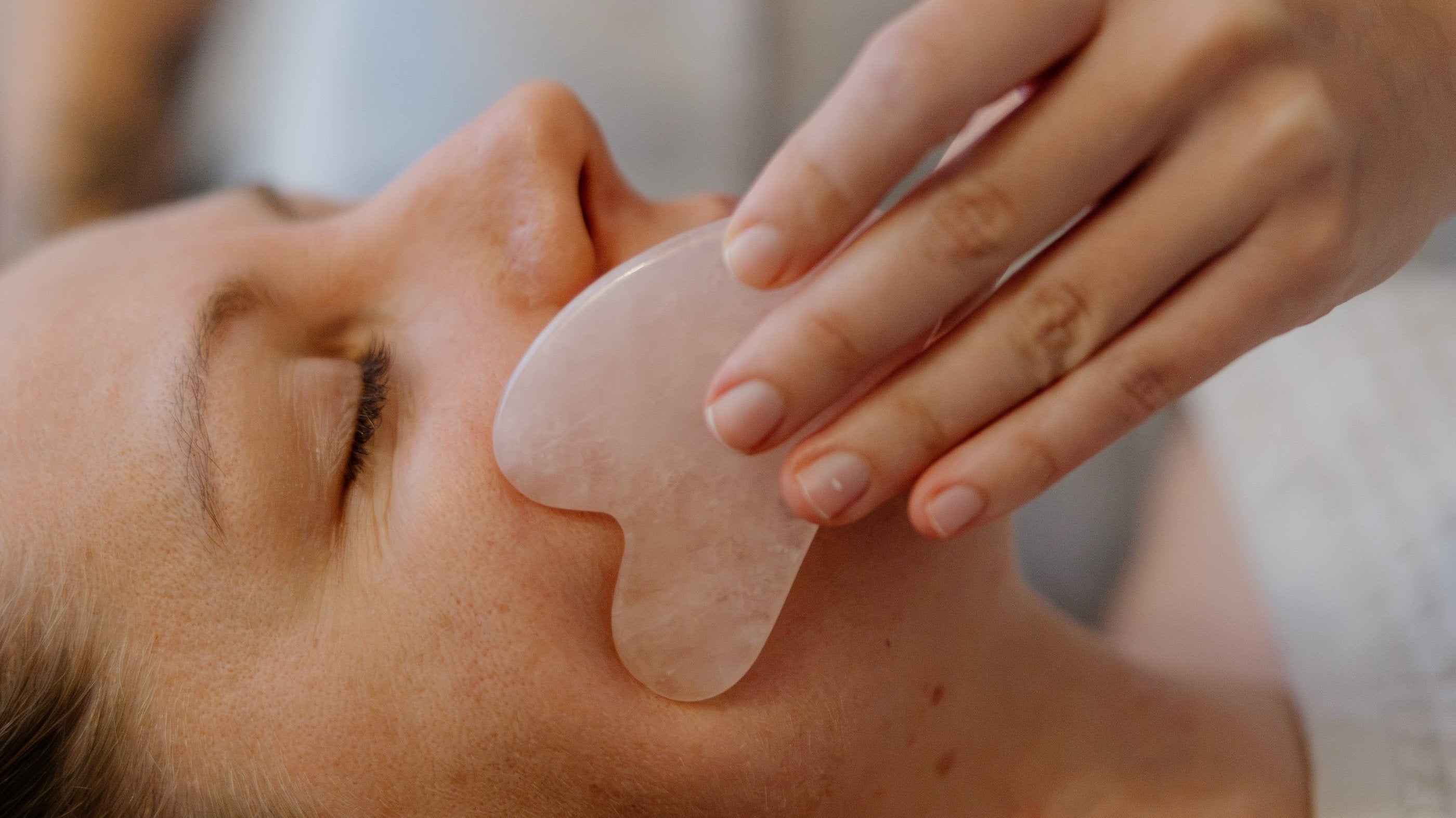 Facial gua sha treatment using a rose quartz tool at Vyne Health, Miami, Gold Coast